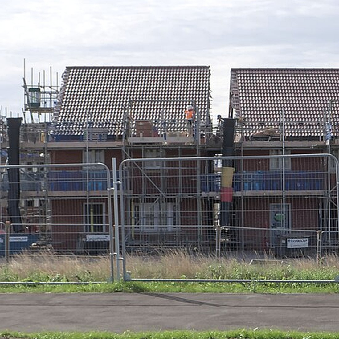 Brick houses with tiled roofs and scaffold